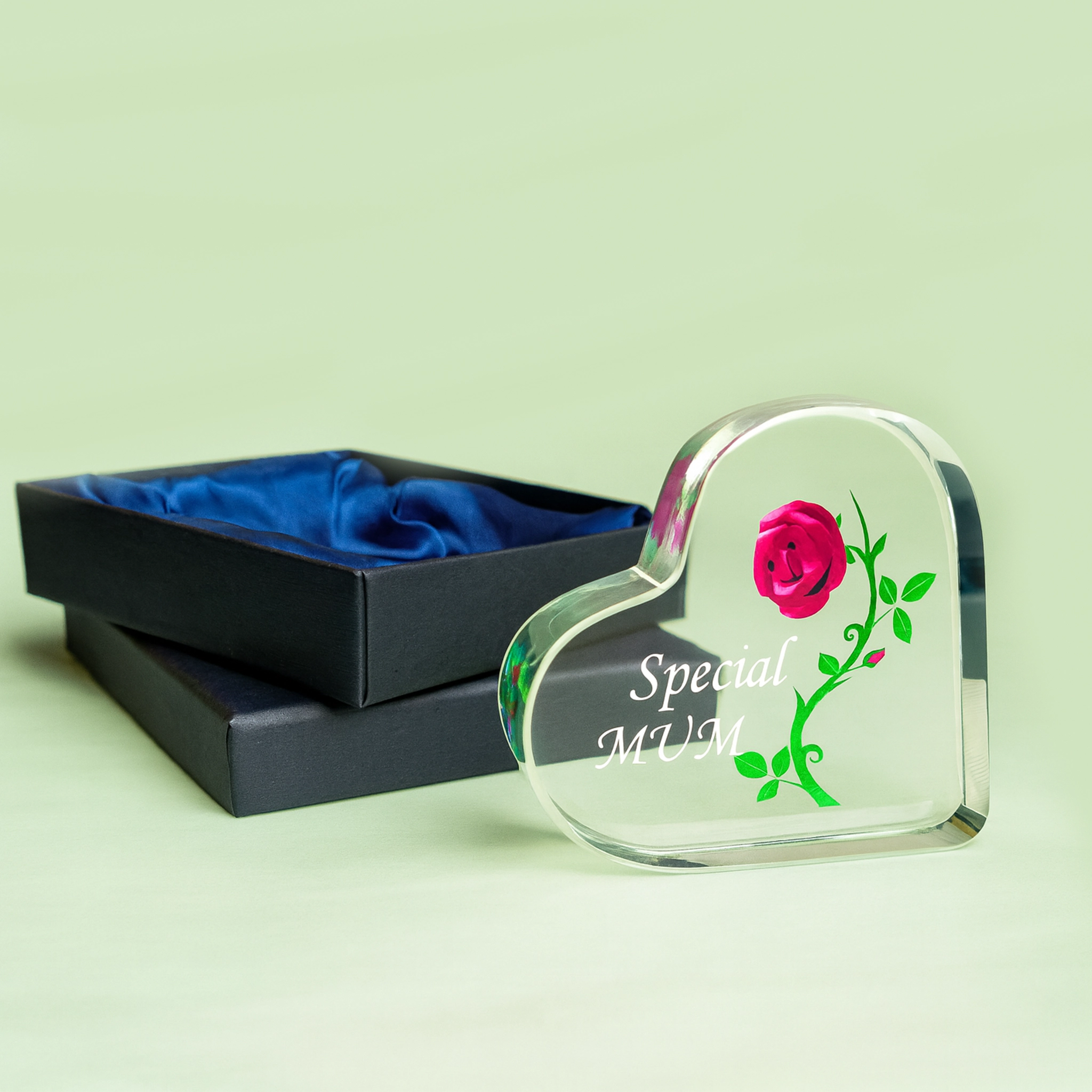 Heart-shaped glass ornament with rose design and 'Special Mum' engraving in a black box on a light green background